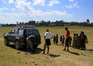 Children Gather Around the Car