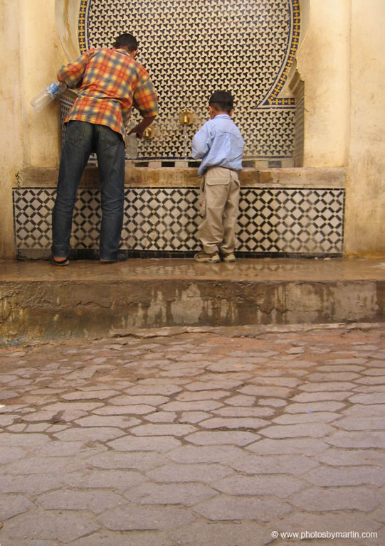 Man and Boy at Water Fountain