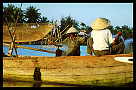 Fishermen Mending Their Nets at Sunset